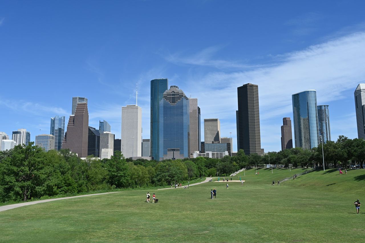 Downtown Houston skyline beyond green parkland